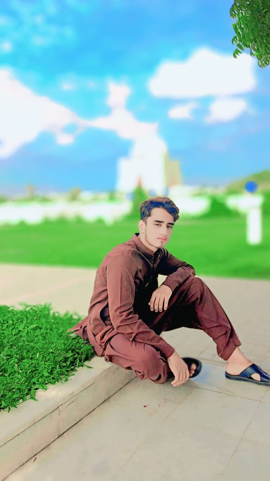 Portrait of Saqib seated outdoors